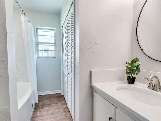 bathroom with vanity, hardwood / wood-style floors, and shower / tub combo with curtain