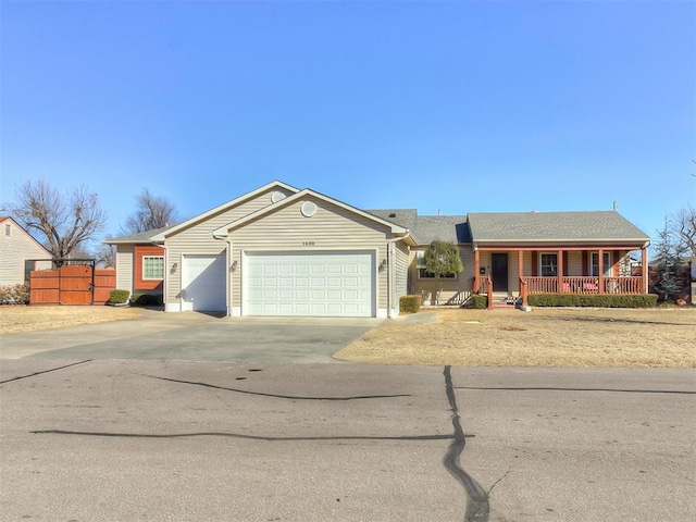 ranch-style home with a porch and a garage