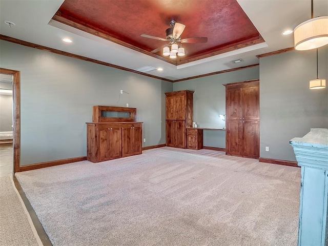 unfurnished living room with light carpet, crown molding, a raised ceiling, and ceiling fan