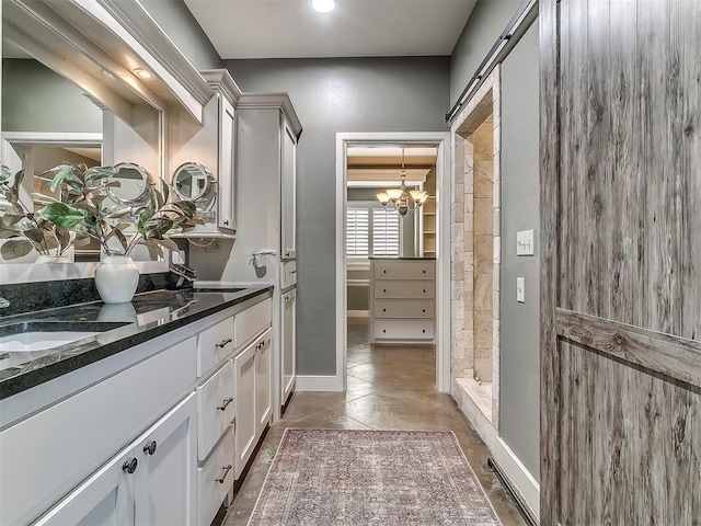 interior space with vanity, tile patterned flooring, a chandelier, and walk in shower