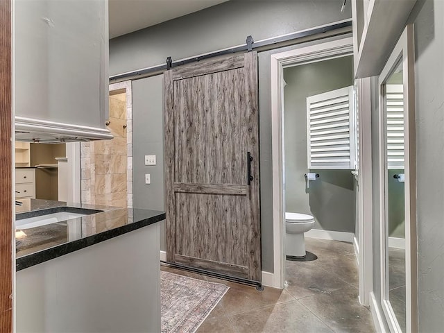 bathroom featuring vanity, tile patterned flooring, and toilet