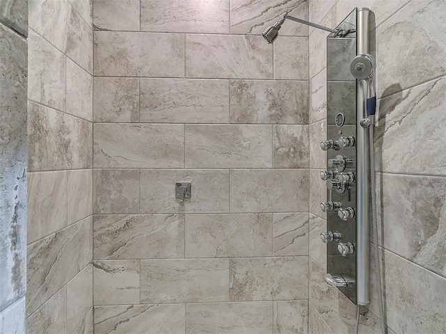 room details featuring a tile shower