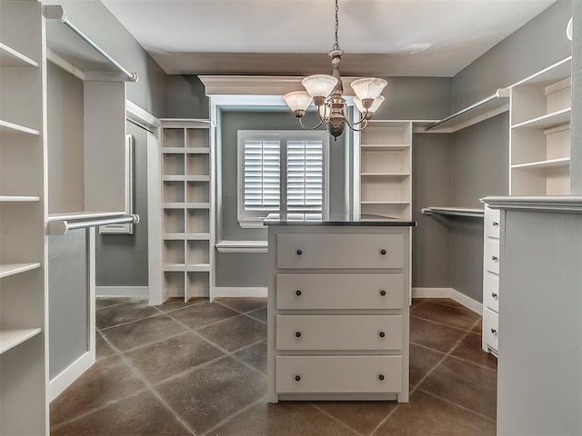 spacious closet featuring a chandelier