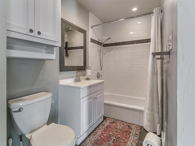 full bathroom featuring vanity, toilet, and shower / bathtub combination with curtain