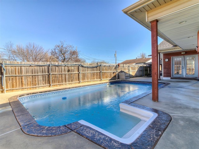 view of pool with a patio area and french doors