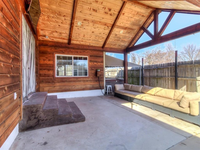 unfurnished sunroom featuring wood ceiling, plenty of natural light, and vaulted ceiling with beams