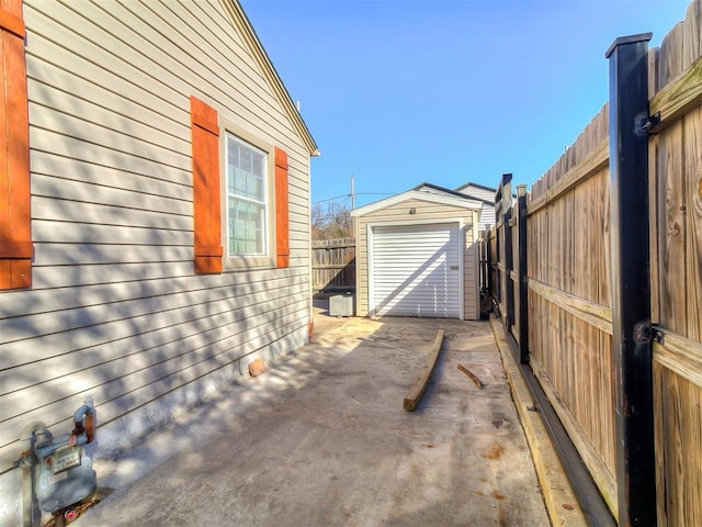 view of home's exterior with an outdoor structure and a patio area