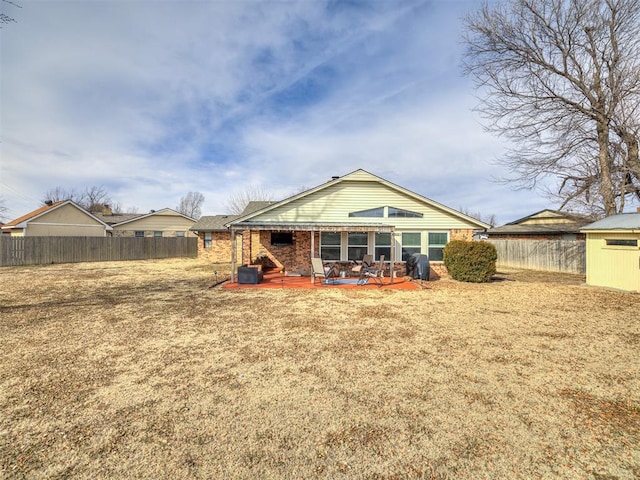 rear view of house with a yard