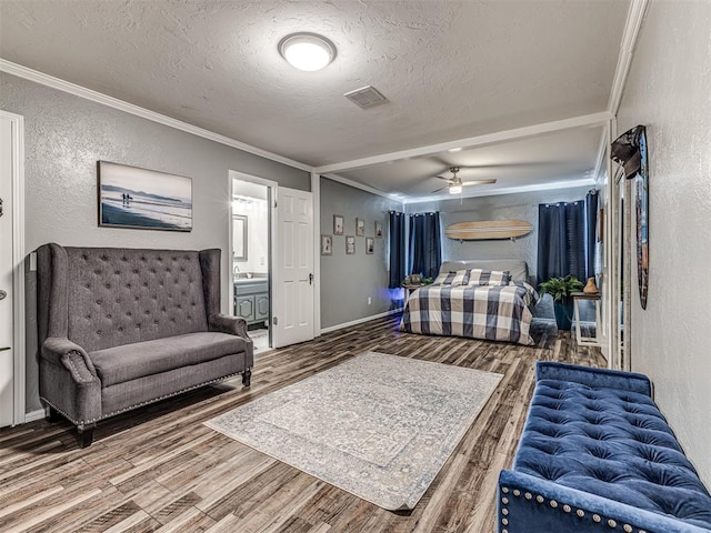 bedroom with ornamental molding, hardwood / wood-style floors, and a textured ceiling