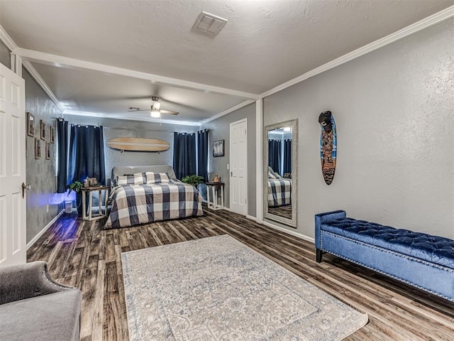 bedroom featuring ceiling fan, ornamental molding, wood-type flooring, and a textured ceiling