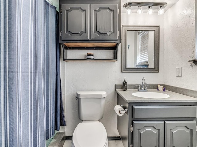 bathroom featuring vanity, toilet, and walk in shower