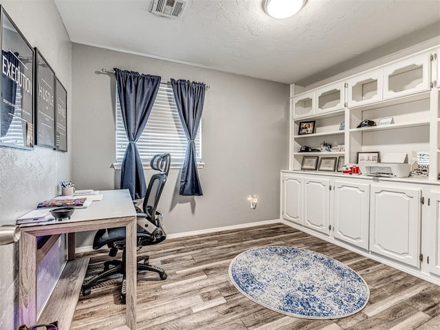 office featuring hardwood / wood-style floors and a textured ceiling