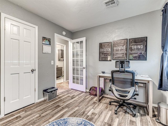 office area with hardwood / wood-style flooring and french doors