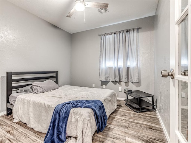 bedroom featuring hardwood / wood-style floors and ceiling fan