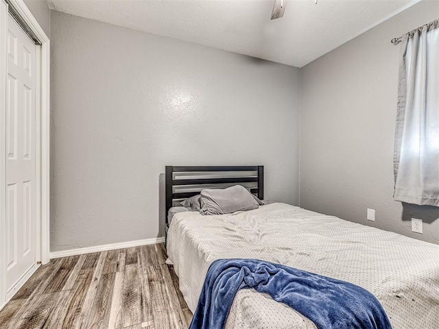 bedroom with hardwood / wood-style floors and ceiling fan