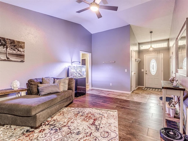 living room with lofted ceiling, hardwood / wood-style floors, and ceiling fan