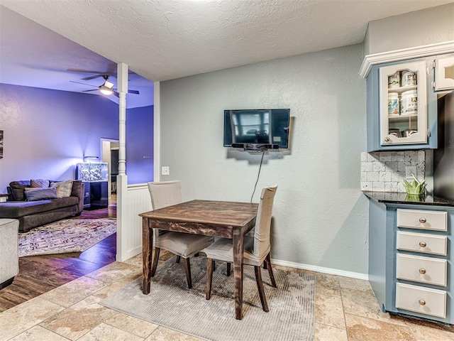 dining room with ceiling fan and a textured ceiling