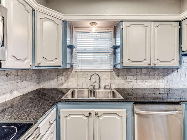 kitchen featuring dishwasher, sink, white cabinets, and backsplash