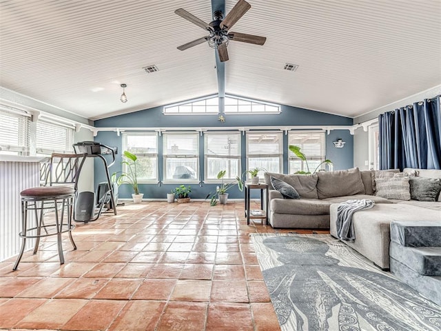 interior space with lofted ceiling, tile patterned flooring, and ceiling fan