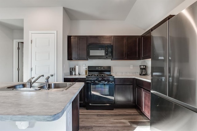 kitchen with dark brown cabinetry, sink, black appliances, and dark hardwood / wood-style floors