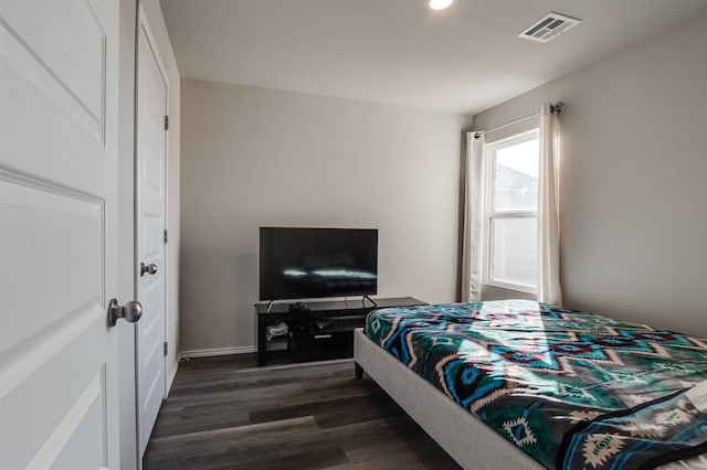 bedroom with dark wood-type flooring