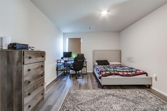 bedroom with dark wood-type flooring