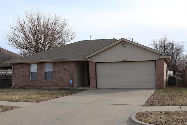 ranch-style house featuring a garage and central AC