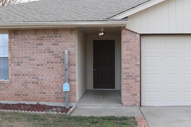 doorway to property with a garage