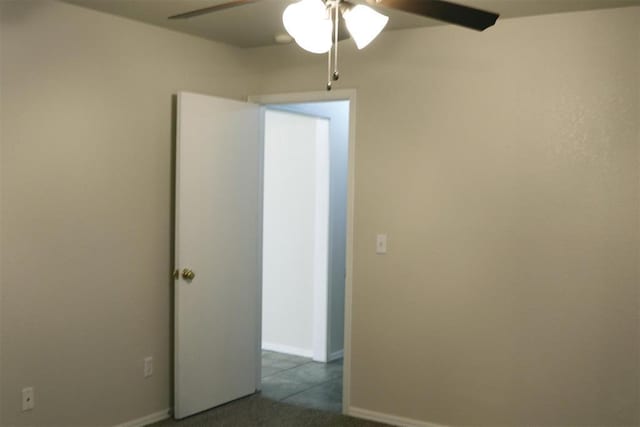 empty room featuring carpet and ceiling fan