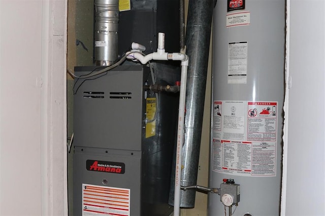 utility room with heating unit and water heater