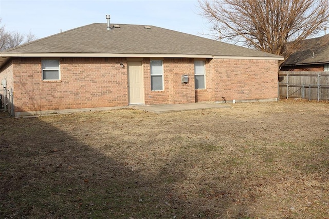 rear view of house with a lawn and a patio area