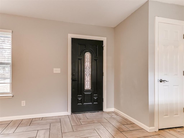 entryway featuring plenty of natural light and baseboards