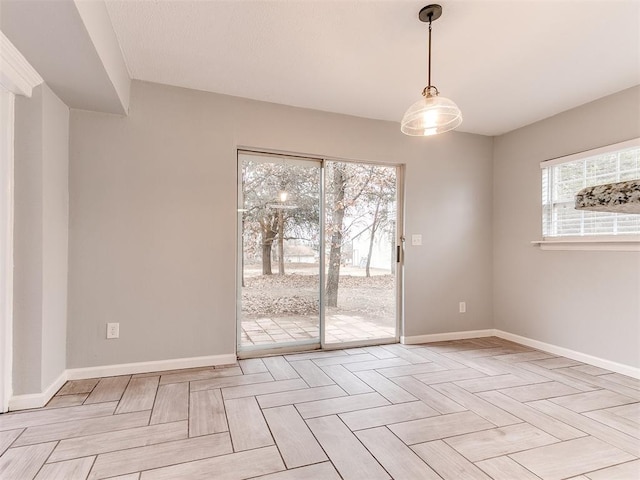 spare room with baseboards