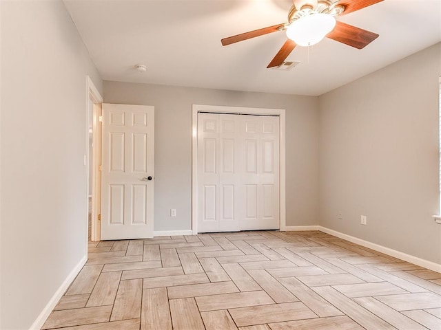 unfurnished bedroom with ceiling fan, baseboards, visible vents, and a closet