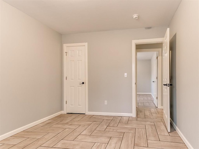 spare room featuring baseboards