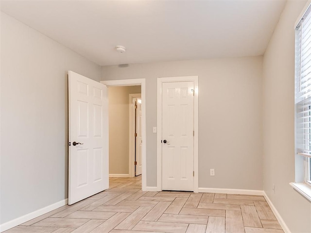 unfurnished bedroom with baseboards