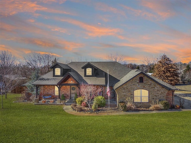 view of front of house with a patio and a lawn