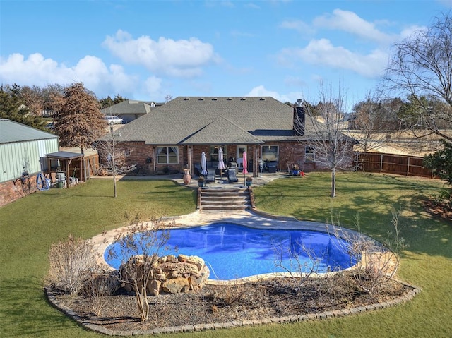 view of swimming pool with a patio and a lawn