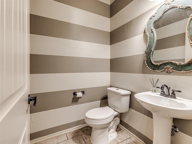 bathroom featuring tile patterned floors and toilet