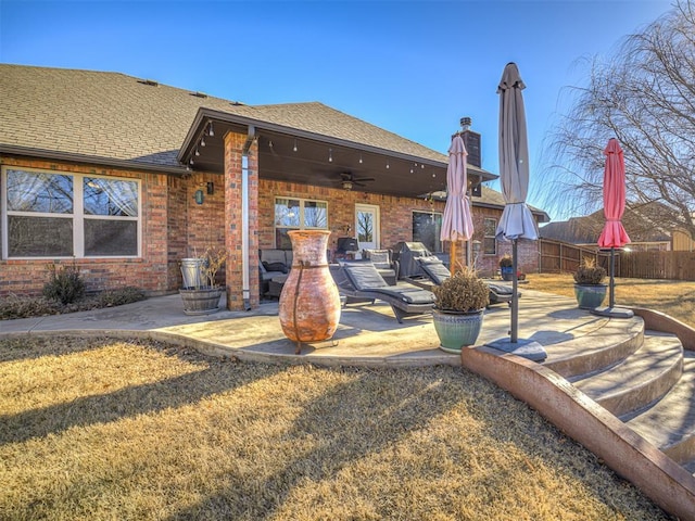 rear view of house with a patio, a yard, and ceiling fan