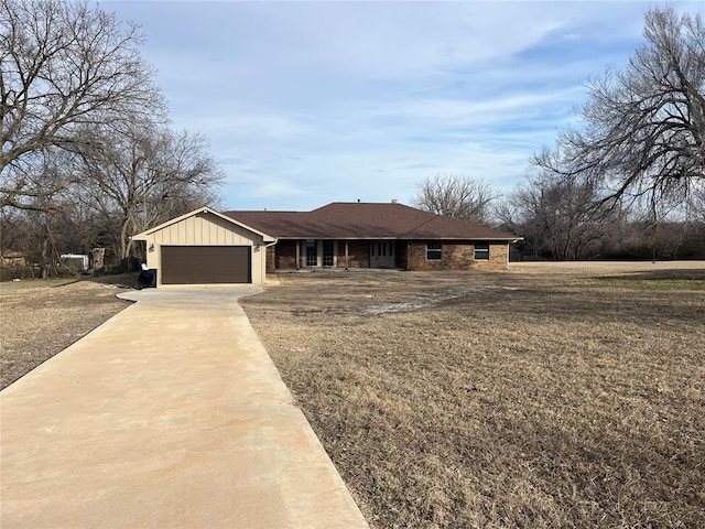 single story home with a garage and a front yard