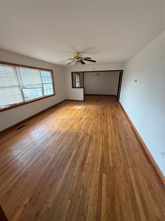 spare room featuring ceiling fan and light hardwood / wood-style flooring