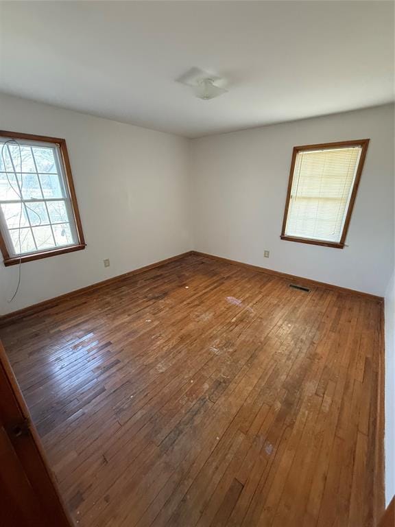 unfurnished room featuring hardwood / wood-style flooring