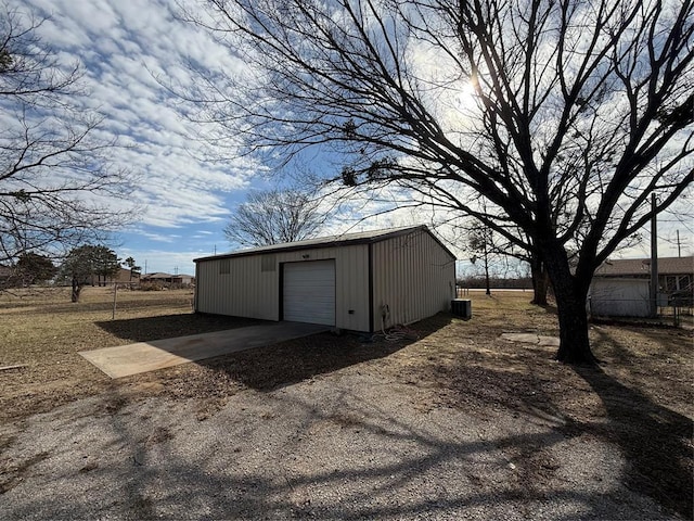 view of outbuilding featuring a garage and central air condition unit