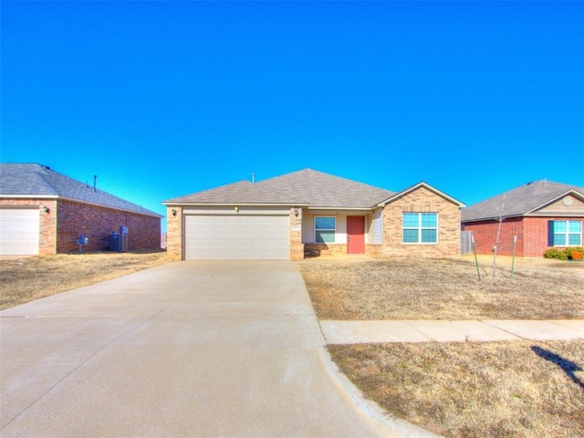 single story home with cooling unit and a garage