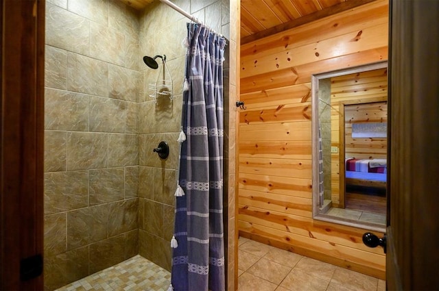 bathroom with tile patterned flooring, curtained shower, and wooden walls