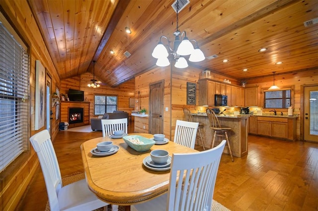 dining room with wood-type flooring, sink, vaulted ceiling, and wooden ceiling