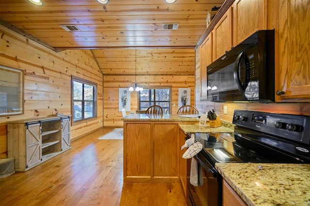 kitchen featuring pendant lighting, black appliances, lofted ceiling, light stone counters, and kitchen peninsula