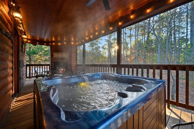 wooden terrace with a hot tub