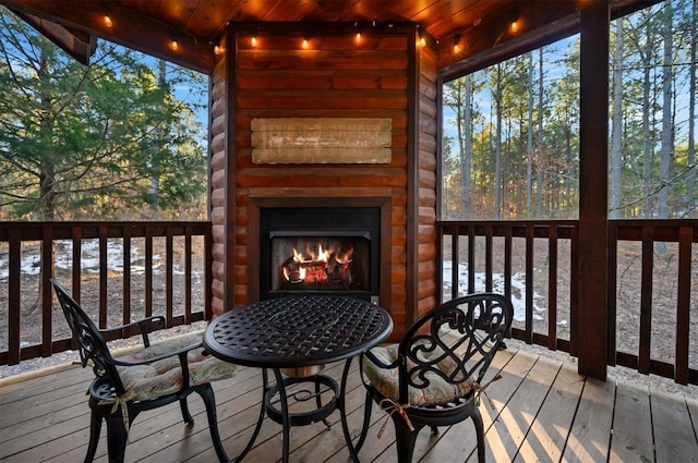 wooden terrace with a fireplace